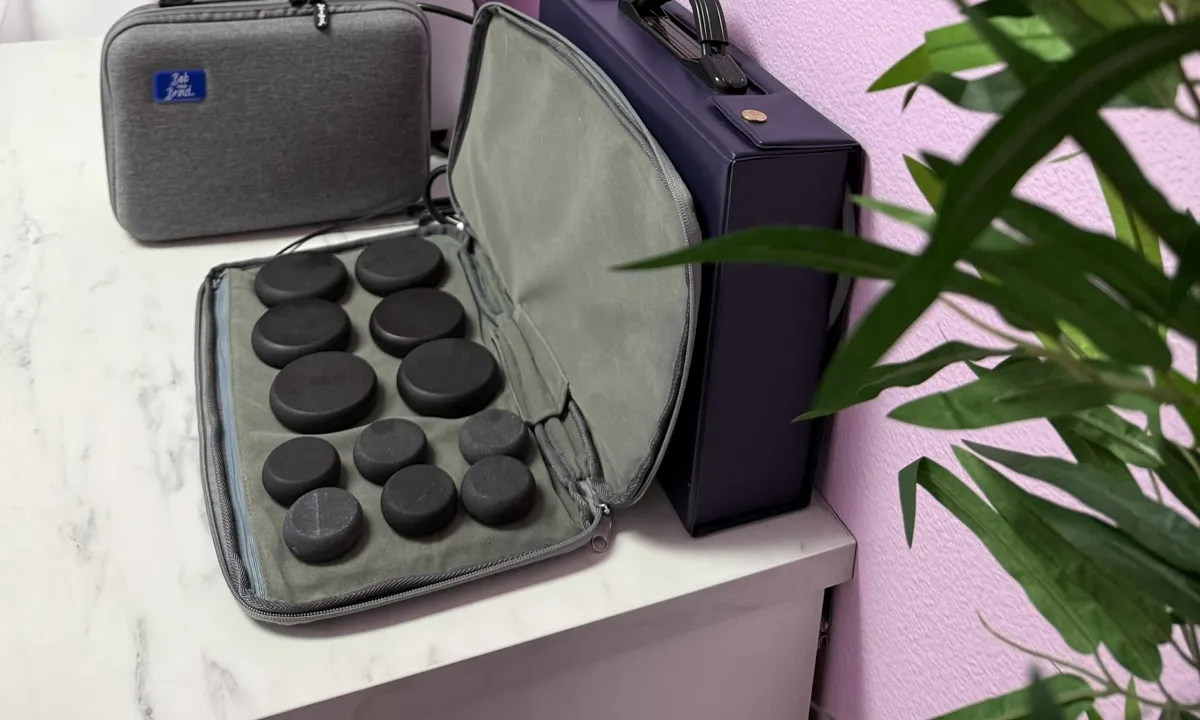 Hot stone massage kit laid open on the marble counter