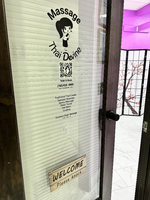 The Massage Devine suite door with the studio logo and welcome sign